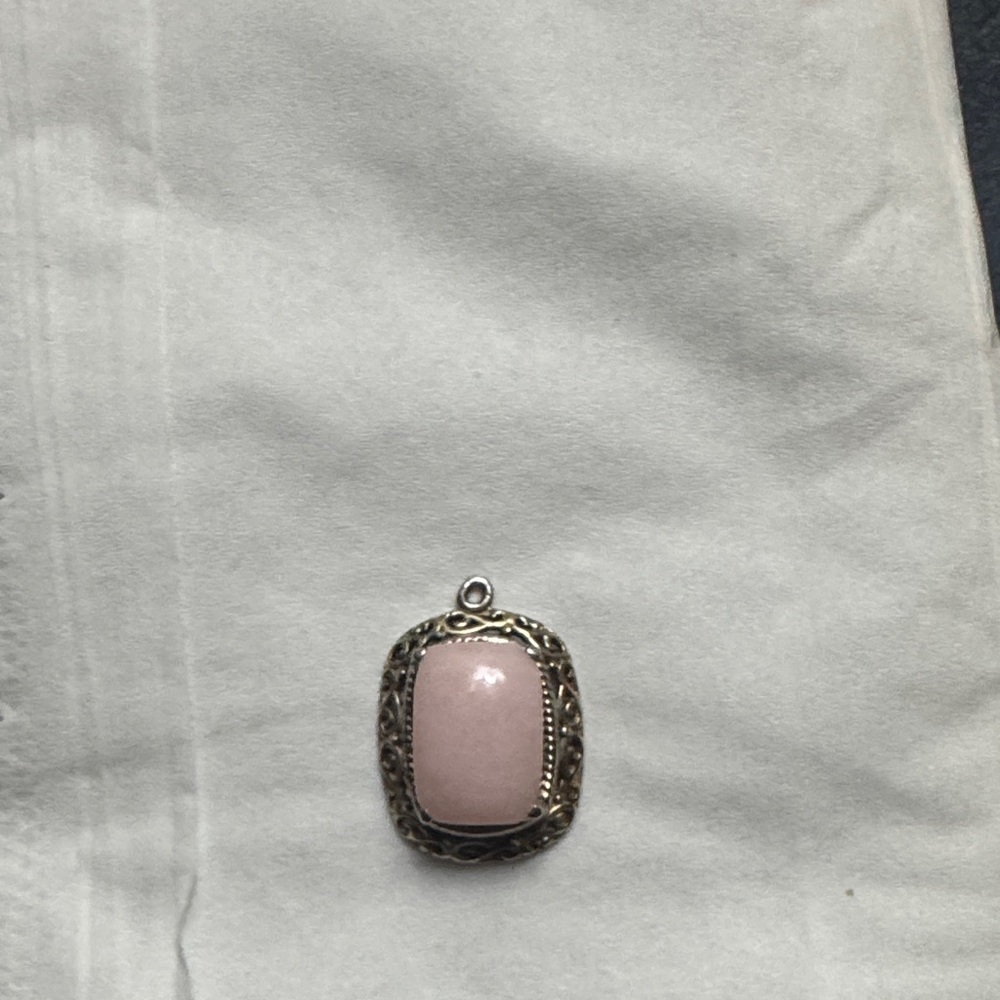 Vintage sterling silver pendant with a pink cabochon stone.